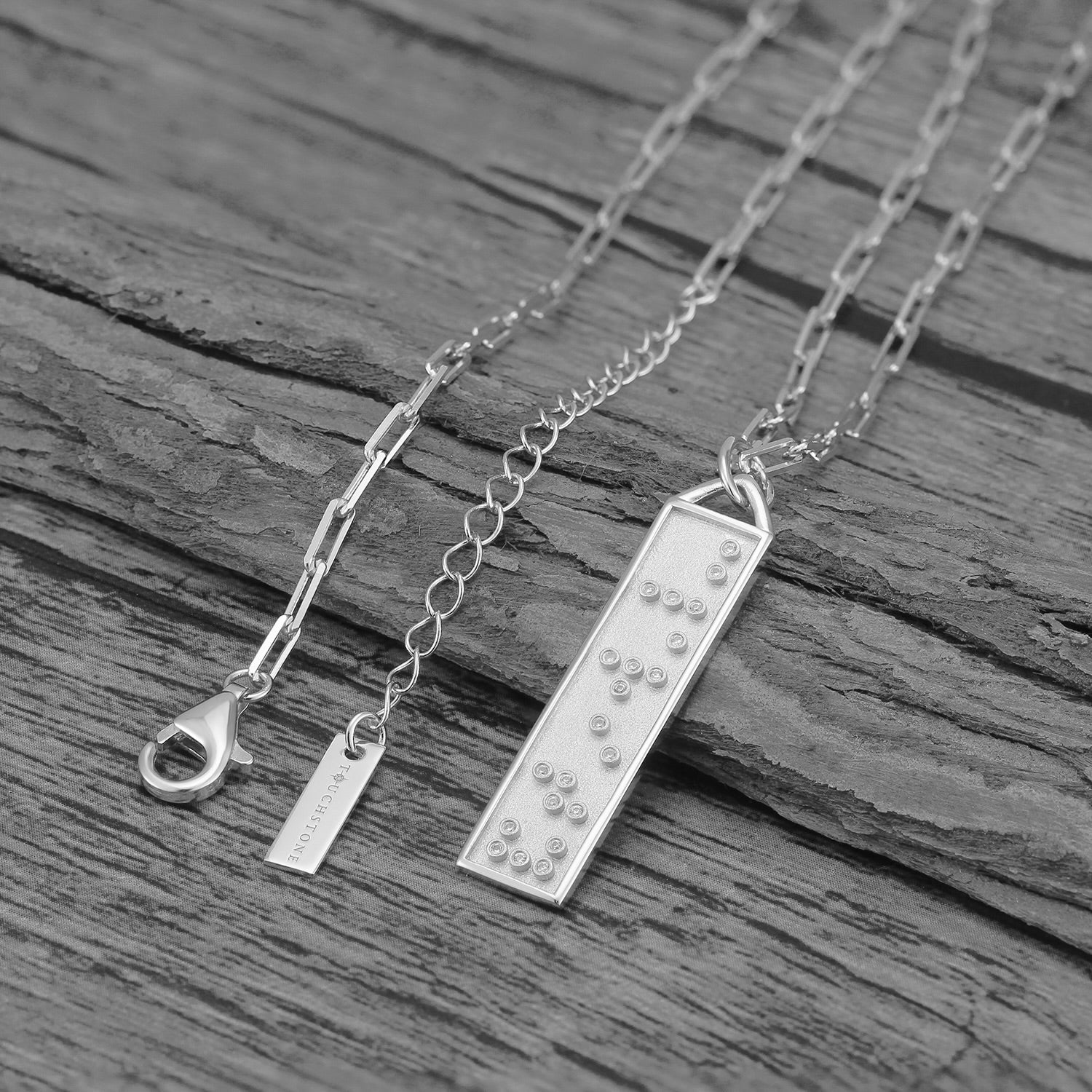 Touchstone Clarity Bar Necklace Silver on wood surface
