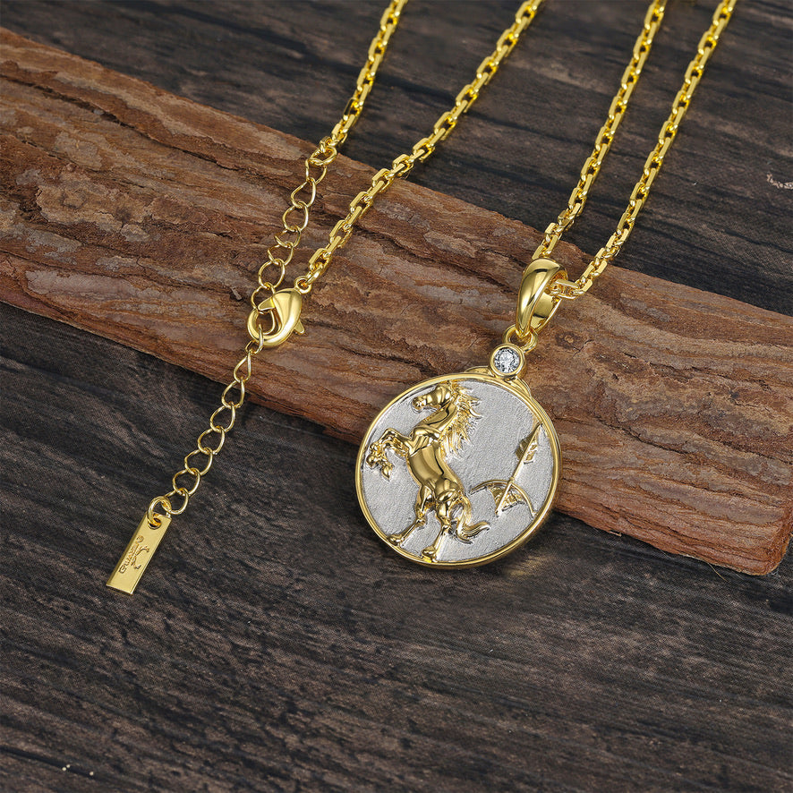 Sagittarius Horse and Arrow Zodiac pendant in gold and silver on wooden surface