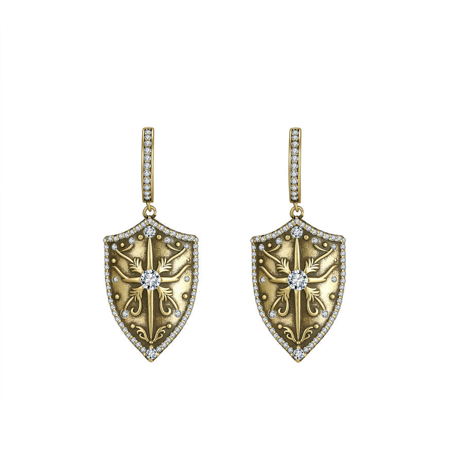 Antique Gold shield-shaped earrings with intricate designs and channel cut crystals on a white background