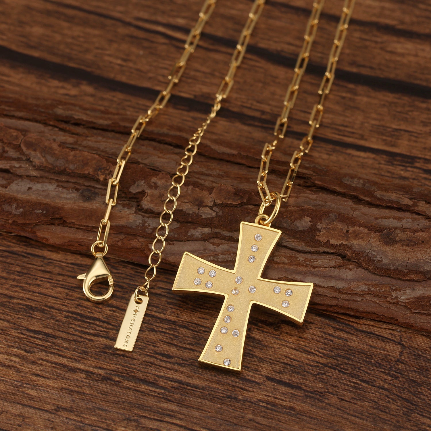 Touchstone Cross God/Love Braille Crystals Necklace Gold on wooden surface