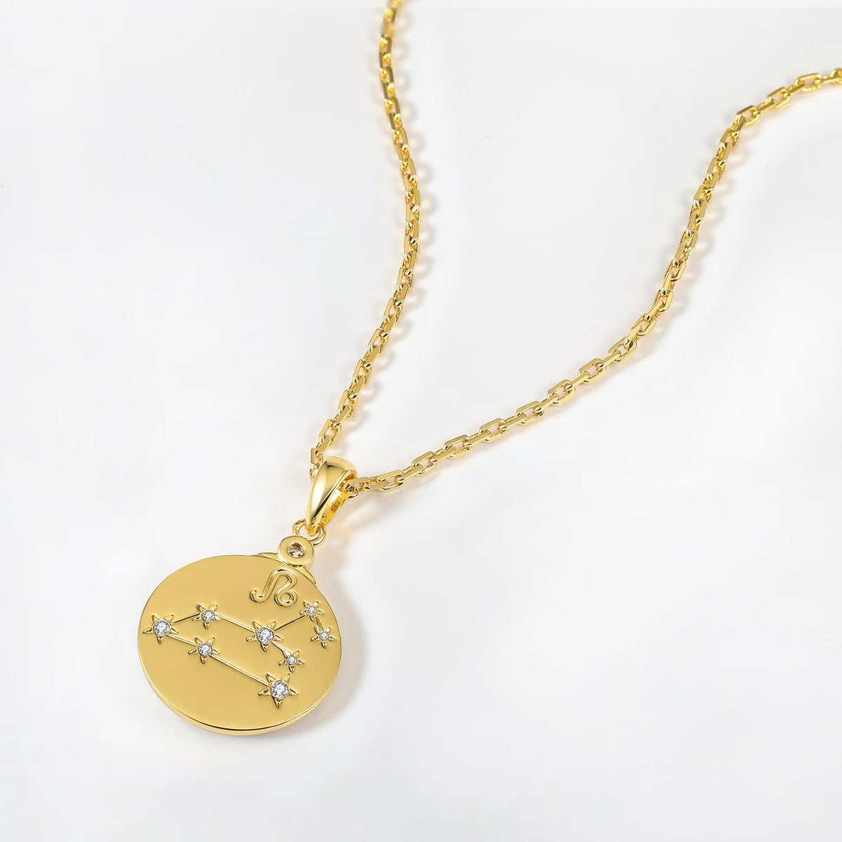 Gold necklace with a round pendant featuring Leo Zodiac star constellations on a white background