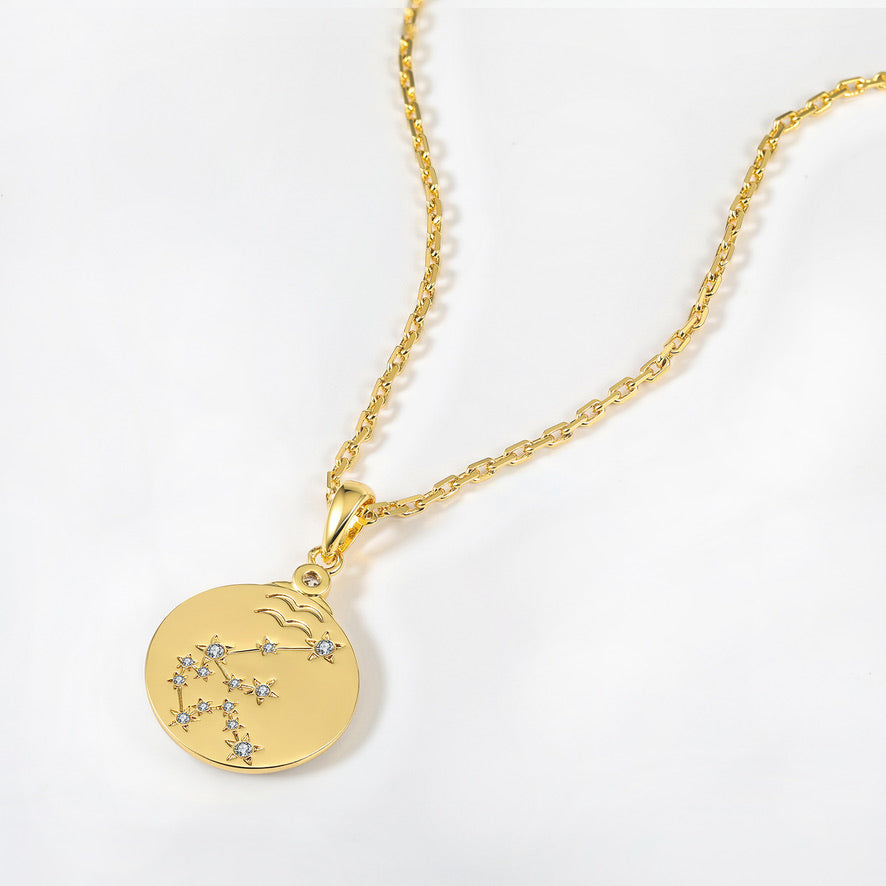 Gold necklace with a zodiac constellation pendant on a white background