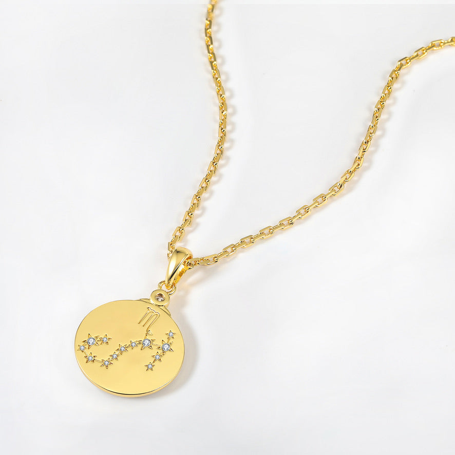 Gold necklace with a zodiac scorpio constellation pendant on a white background