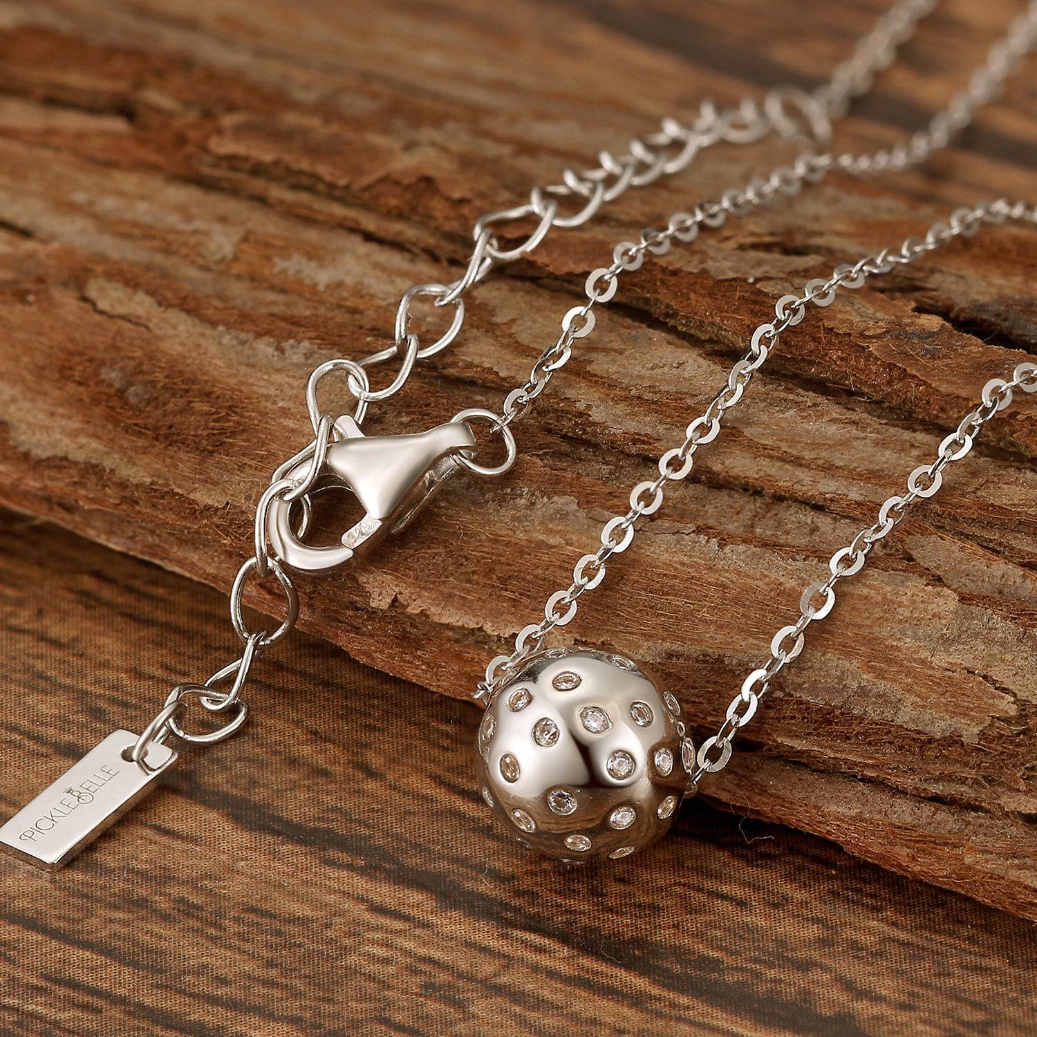 Pickleball Babe Belle BLING Ball Silver with Crystals Necklace on wooden surface