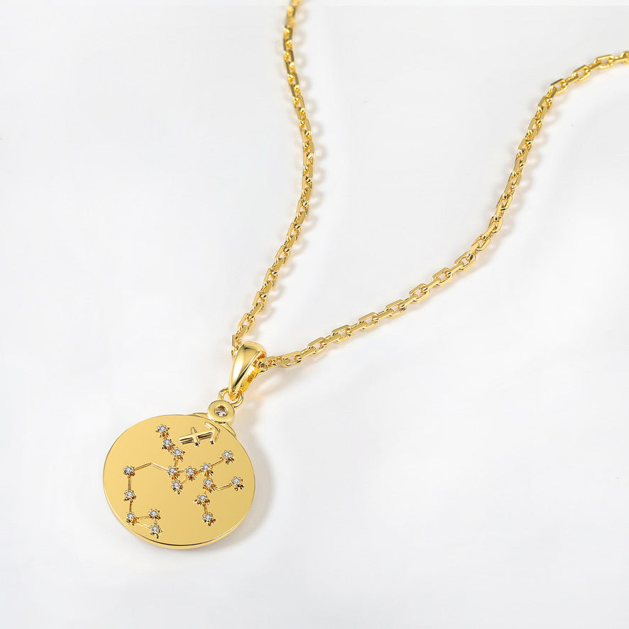 Gold necklace with a round pendant featuring the Sagittarius star constellations on a white background