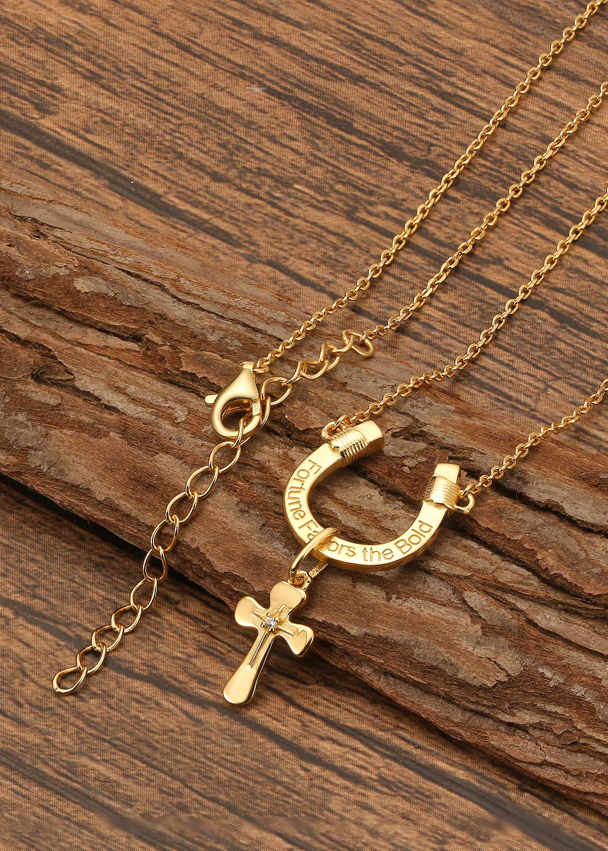 Saints Fortune Favors The Bold Necklace Horseshoe with Cross Charm on wooden surface