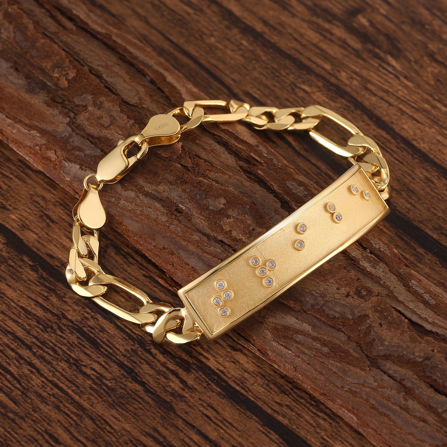 Touchstone Tribe ID Link Bracelet in Gold Braille Crystals on wooden surface