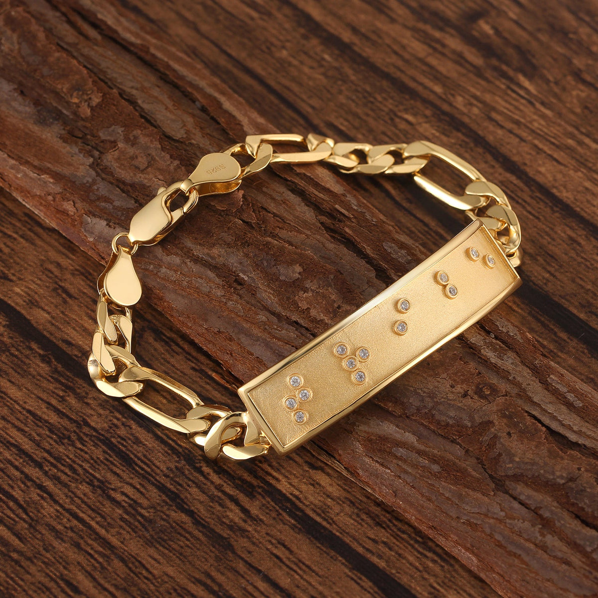 Touchstone Tribe ID Link Bracelet in Gold Braille Crystals on wooden surface