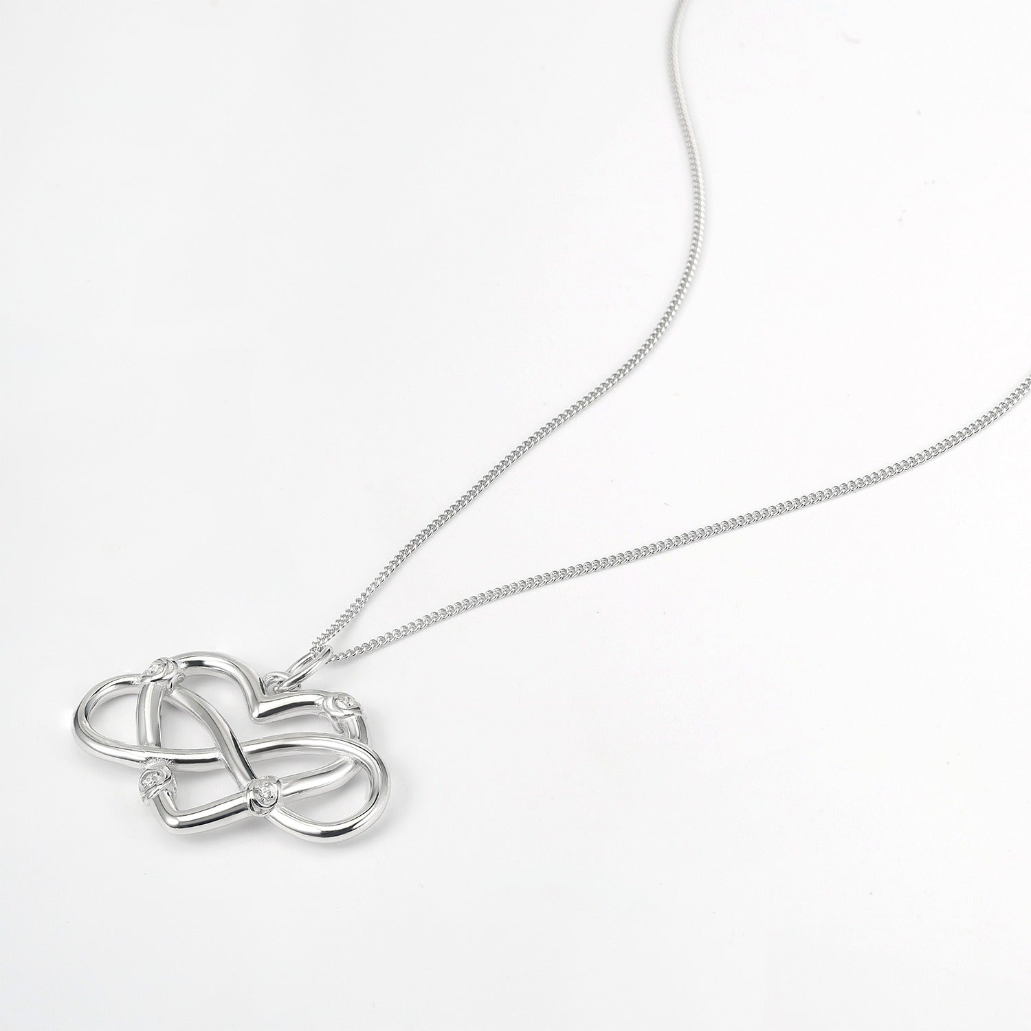 Silver Endless Love Infinity Heart necklace on silver chain on white background