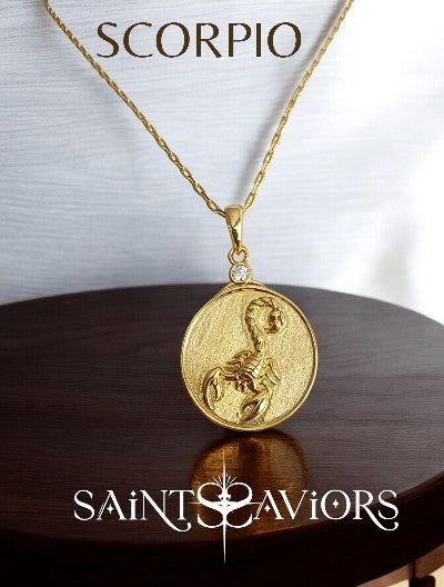 Gold Scorpio Zodiac pendant necklace with 'Scorpio' text on a wooden surface,