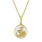 Gold and silver Capricorn pendant on a gold chain against a white background