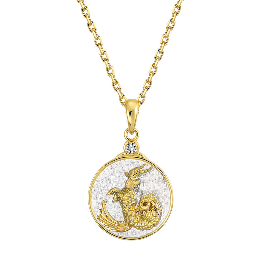 Gold and silver Capricorn pendant on a gold chain against a white background