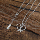Silver necklace with a heart-shaped pickleball paddles pendant on a wooden surface