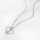 Silver necklace with intersecting pickleball paddle pendant on a light gray background