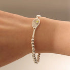 Lovematch Silver bead stretch bracelet with tennis racquet and ball design on a model 