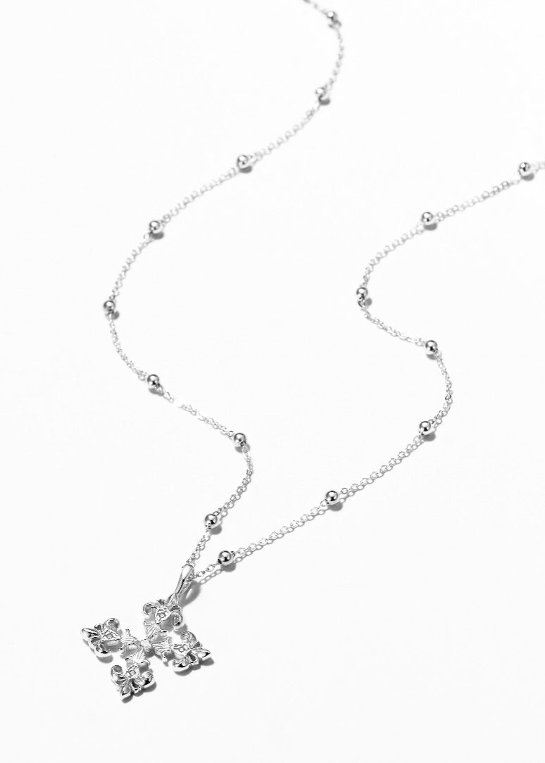 Saints and Saviors Silver necklace with a four-sided fleur de lis pendant on a white background