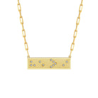 Gold necklace with a rectangular pendant featuring small crystals in Braille spelling He is Greater Than I on a white background