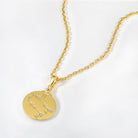 Gold necklace with a zodiac Gemini constellation pendant on a white background