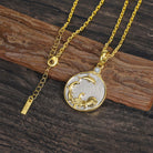 Gold and silver Aquarius Zodiac pendant necklace with a water urn and leaping dolphins shown on a wooden surface