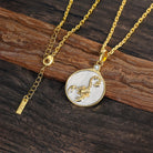 Gold and silver Scorpio zodiac pendant necklace on a wooden surface