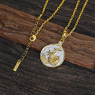 Gold chain necklace with a decorative Gold and Silver Capricorn Zodiac pendant on a wooden surface