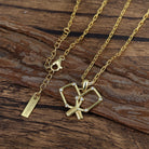 Gold necklace with a pickleball crossed paddles pendant on a wooden surface