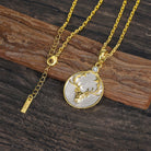 Gold and silver necklace with a Virgo zodiac pendant with deer head on a wooden surface