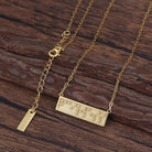 Touchstone Fearless Mini-Bar Necklace in Braille crystals in Gold on a wooden background