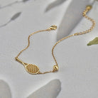 LoveMatch Tennis Ace Racquet and Ball on Gold Chain Bracelet on white surface
