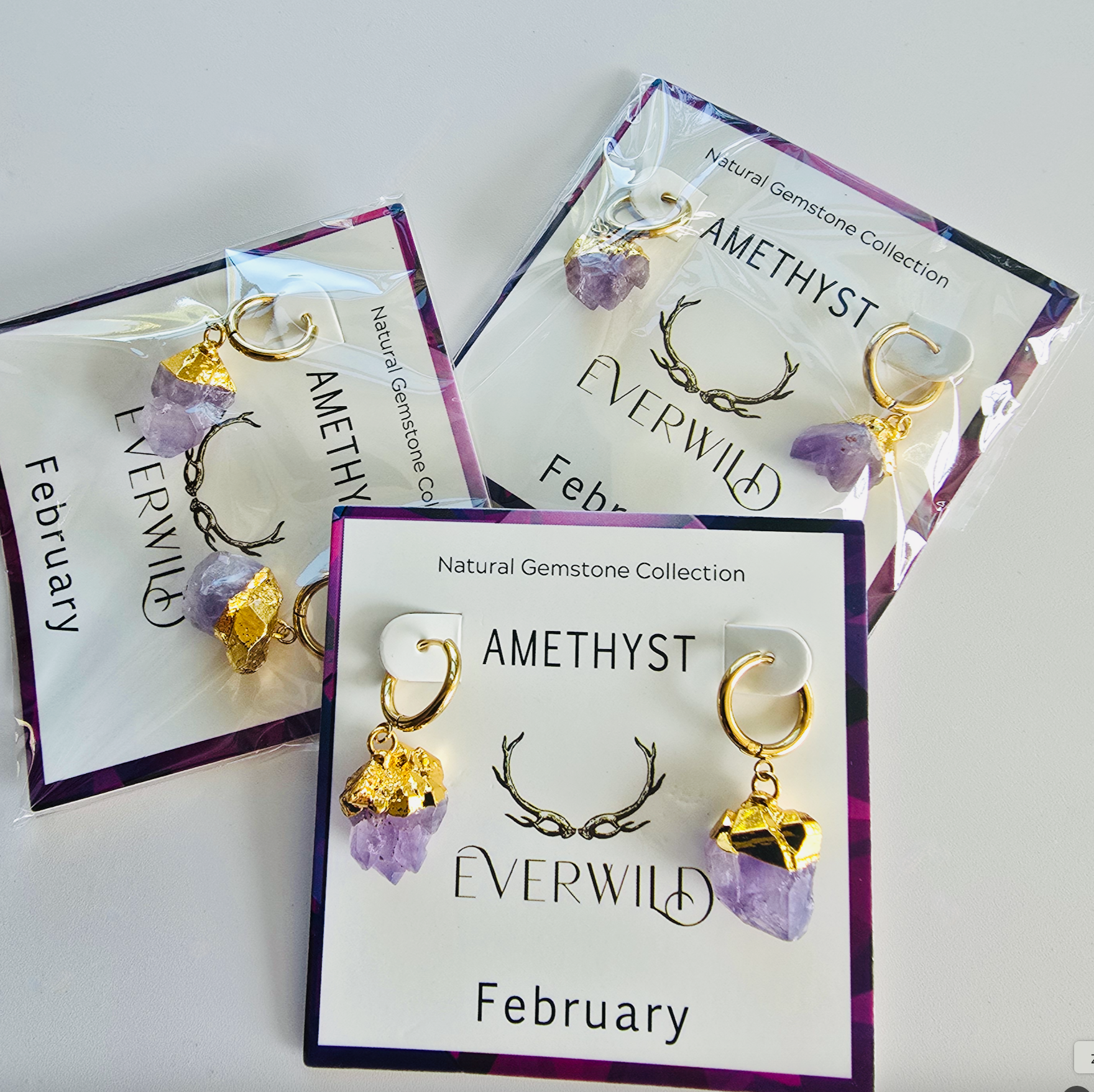 Amethyst earrings on display with 'Everwild' branding on a white background