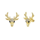 Gold deer head earrings with antlers and gemstones on a white background